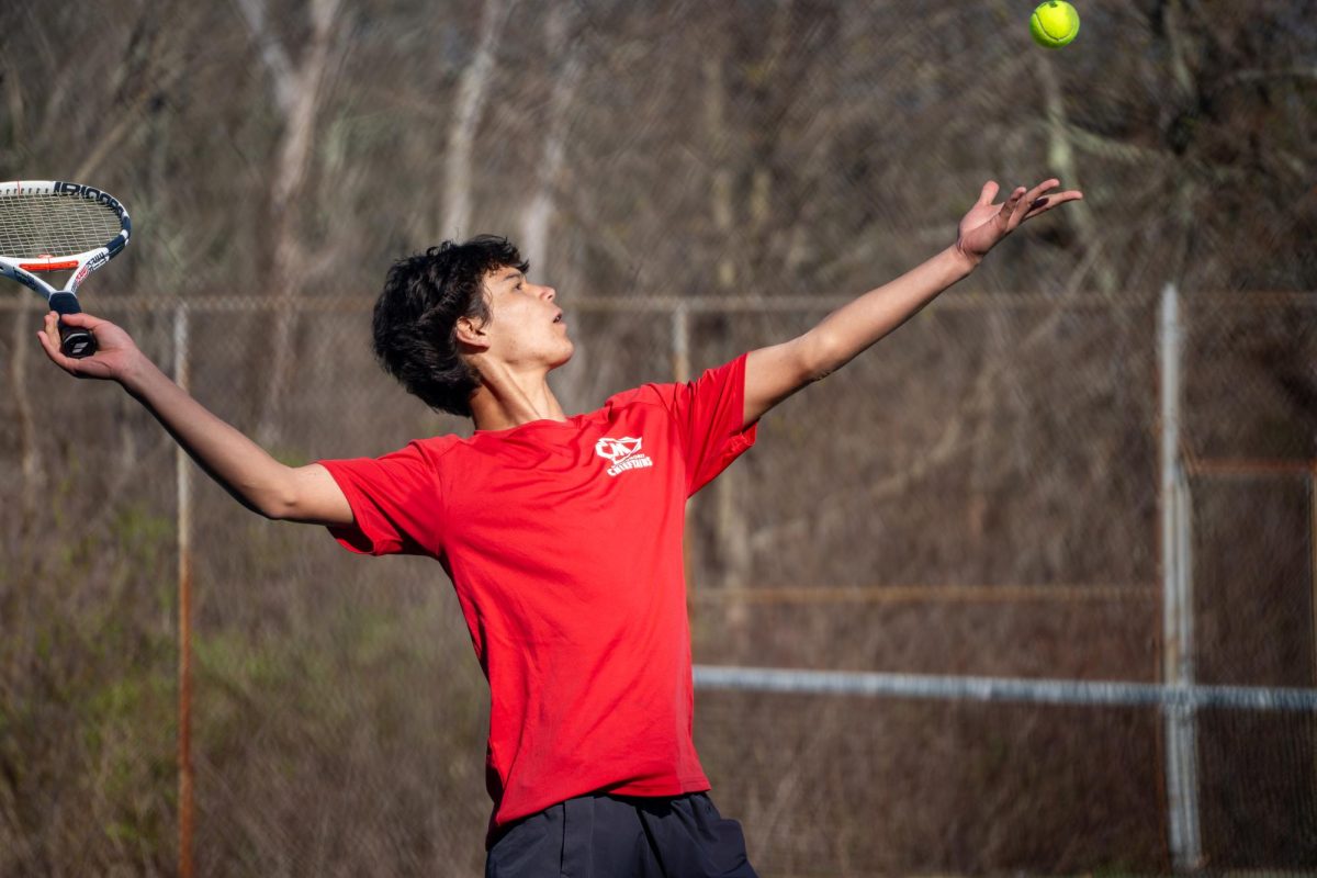 Sophomore+Kai+Hird+Serving+The+Ball+In+Singles+Match