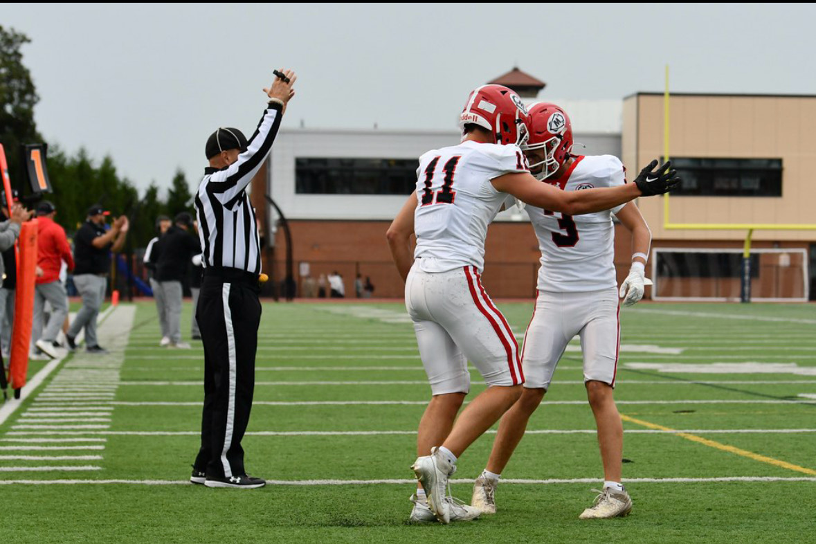 Masco's Ryan Richardson congratulating Jack Fabiano after scoring a touchdown 