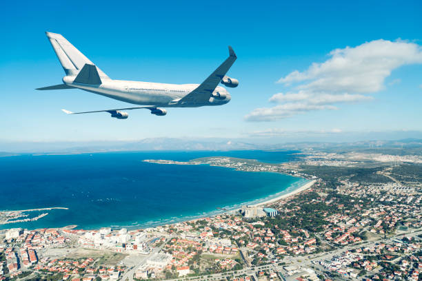 airplane flying over a coast city