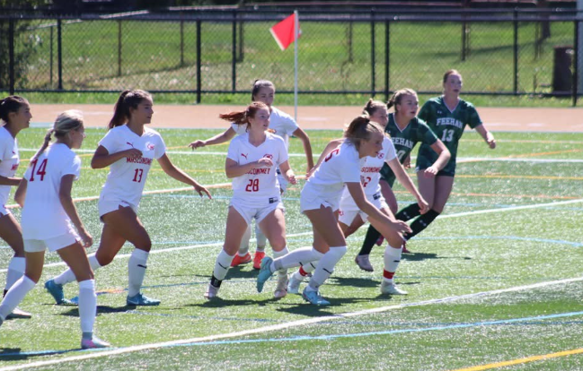   The Chieftains rushing after a free kick being served by the Shamrocks.
