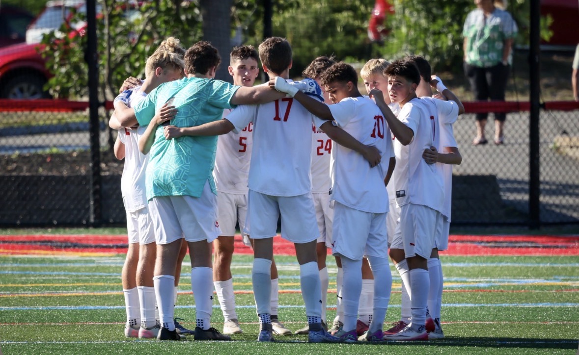 The starting lineup huddles up before kickoff against a tough Marblehead team