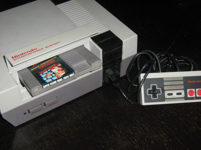 Super Mario Bros. cartridge in the Nintendo Entertainment System. NES Super Mario by Yagamichega, CC BY 3.0 , via Wikimedia Commons